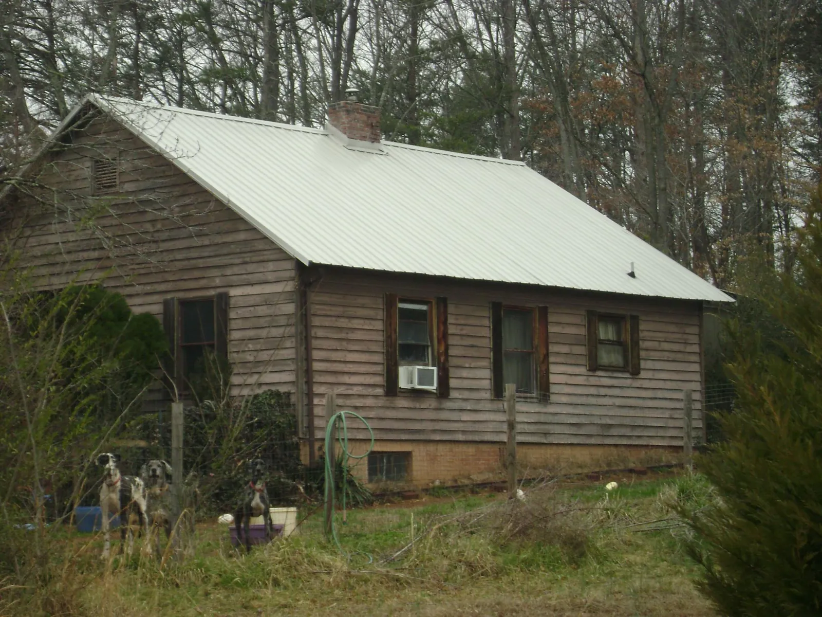 White metal roof on an old wood sided farmhouse, from a Metal Roof Installation job in Granby